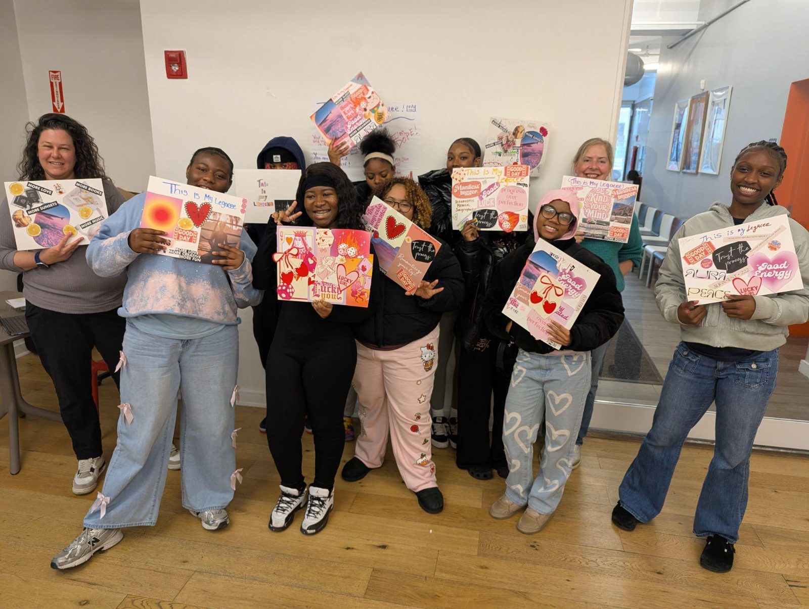 Participants proudly holding up their paintings