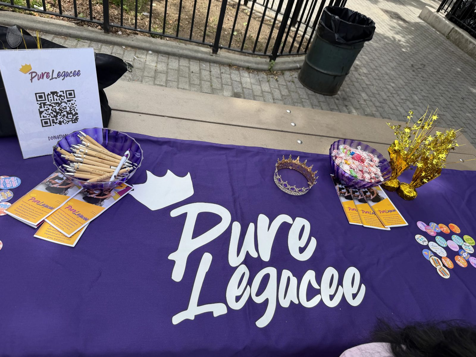 A PureLegacee table set with crowns and event materials